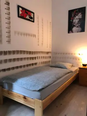 a bedroom with a wooden bed in a room at Nr 3 in Kraków