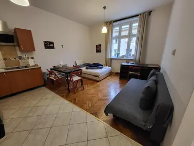 a living room with a couch and a table at Apartament on Kazimierz in Kraków