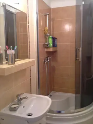 a bathroom with a shower and a sink and a toilet at Apartament on Kazimierz in Kraków
