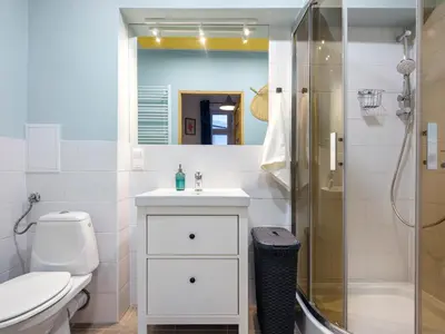 a bathroom with a toilet sink and a shower at Silent blue apartment / Kochanowskigo St in Kraków