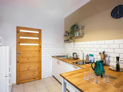 a kitchen with a counter with glasses on it at Silent blue apartment / Kochanowskigo St in Kraków