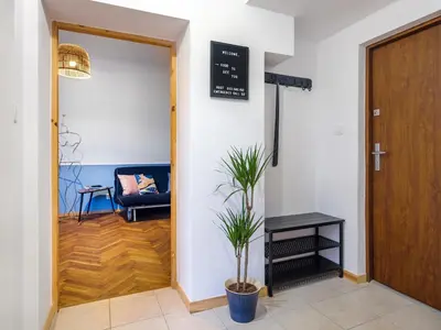 a living room with a blue couch and a table at Silent blue apartment / Kochanowskigo St in Kraków