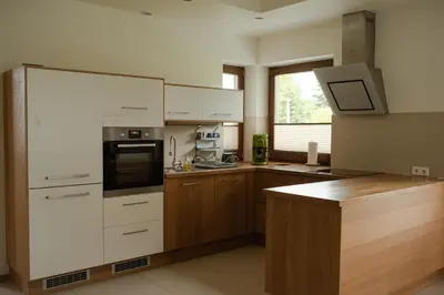 a kitchen with white cabinets and a stove top oven at Apartament Słoneczna Rapsodia - blisko Parku Zdrojowego - piękny widok - ogród - taras in Rabka