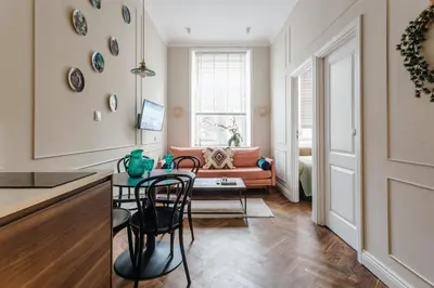 a living room with a table and a couch at Old Town Apartment Kraków in Kraków