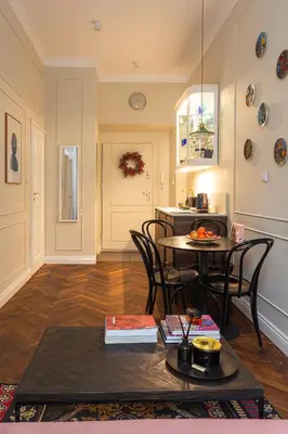 a living room with a table and chairs and a kitchen at Old Town Apartment Kraków in Kraków