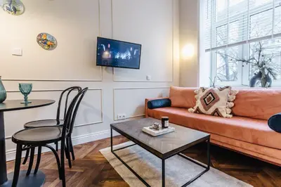 a living room with a couch and a table at Old Town Apartment Kraków in Kraków