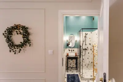 a bathroom with a wreath on the door at Old Town Apartment Kraków in Kraków