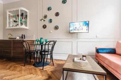 a living room with a table and a couch at Old Town Apartment Kraków in Kraków