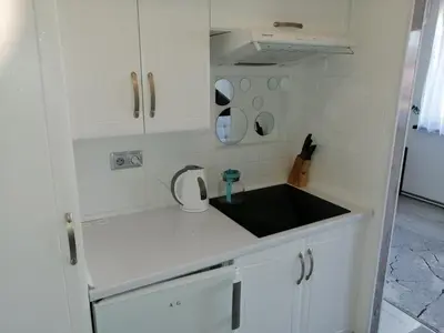 a kitchen with white cabinets and a black sink at Apartament Skawina in Skawina