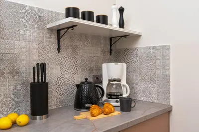 a kitchen counter with a blender and some fruit on it at Cozy Apartment in Old Town in Kraków