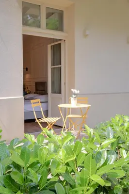 a patio with a table and chairs and a bedroom at Cozy Apartment in Old Town in Kraków