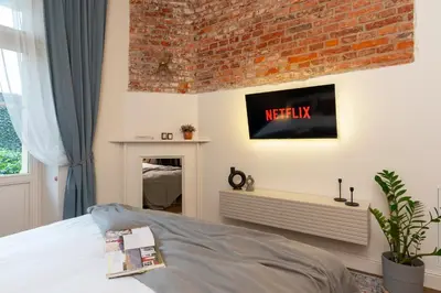a bedroom with a bed and a brick wall at Cozy Apartment in Old Town in Kraków