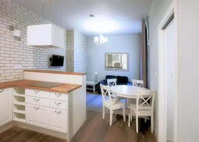 a kitchen and dining room with a table and a dining room at Old Town Apartment in Kraków