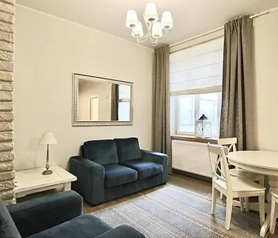 a living room with a couch and a table at Old Town Apartment in Kraków