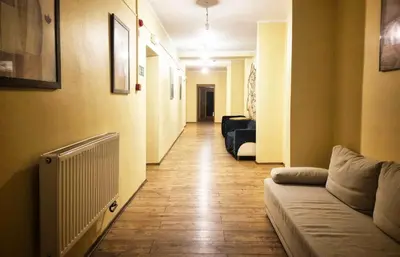 a hallway with a couch and a radiator in a room at 50 People Bis Apartment in Kraków