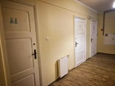 an empty room with a door and a radiator at 50 People Bis Apartment in Kraków