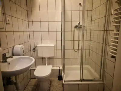 a bathroom with a shower and a toilet and a sink at 50 People Bis Apartment in Kraków