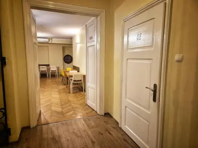 an open door to a dining room with a table at 50 People Bis Apartment in Kraków