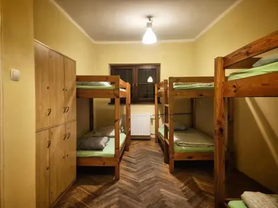 a room with three bunk beds in a room at 50 People Bis Apartment in Kraków