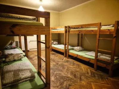a room with three bunk beds in a room at 50 People Bis Apartment in Kraków