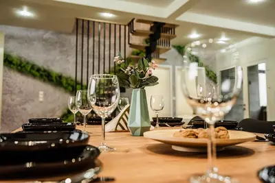 a wooden table with wine glasses and a plate of food at KROSNA92 in Krosna
