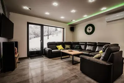 a living room with a leather couch and a table at KROSNA92 in Krosna