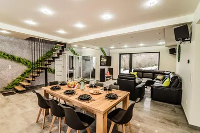 a living room with a wooden table and chairs at KROSNA92 in Krosna