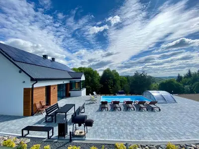 a patio with chairs and a swimming pool at KROSNA92 in Krosna
