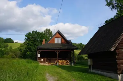 a log cabin with a gambrel roof at Góralska chata z 1930r. in Obidowa