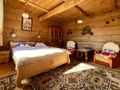 a bedroom with two beds and a window at Góralska chata z 1930r. in Obidowa