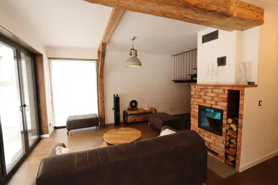 a living room with a couch and a fireplace at Domy Pod Babią in Zawoja