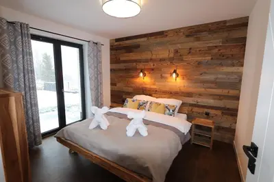 a bedroom with two teddy bears on a bed at Domy Pod Babią in Zawoja