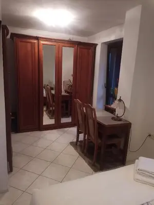a room with a table and chairs and a dining room at Pokój w domu z dużym ogrodem in Kraków