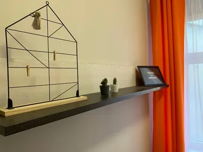 a shelf with a plant and a picture on it at Discover Cracow APARThostel in Kraków