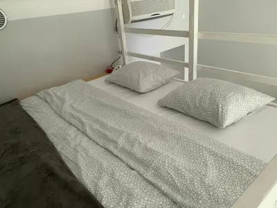 a bed with two pillows on it in a room at Discover Cracow APARThostel in Kraków
