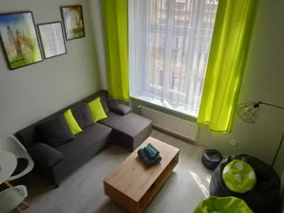 a living room with a couch and a coffee table at Discover Cracow APARThostel in Kraków