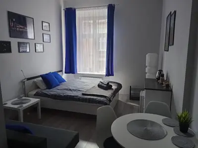 a small room with a bed and a window at Discover Cracow APARThostel in Kraków