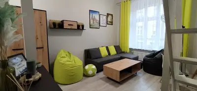 a living room with a couch and a table at Discover Cracow APARThostel in Kraków
