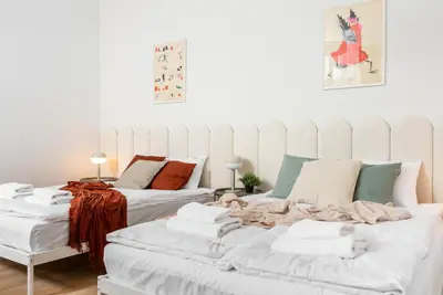 a living room with two beds with blankets at Modern Centrally Located Apartments - by Upstairs in Kraków