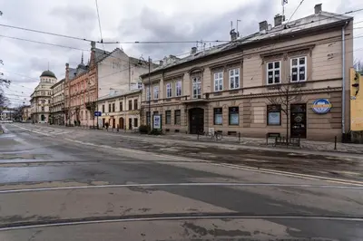 an empty street in an old town with buildings at Modern Centrally Located Apartments - by Upstairs in Kraków
