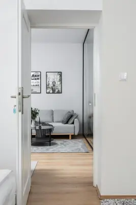 a living room with a couch and a table at Modern Centrally Located Apartments - by Upstairs in Kraków