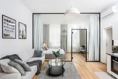 a living room with a couch and a bed at Modern Centrally Located Apartments - by Upstairs in Kraków