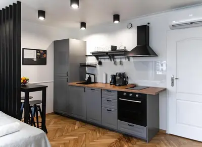 a kitchen with a counter and a stove top oven at Studio Kolberga Kraków in Kraków