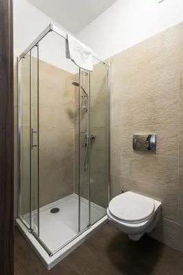 a shower stall with a toilet in a bathroom at G12 Aparthotel in Kraków