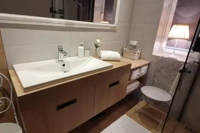 a bathroom with a white sink and a mirror at ZENDA - Przytulny apartament w zacisznym miejscu in Wieprz