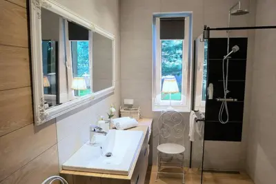 a bathroom with a sink and a shower at ZENDA - Przytulny apartament w zacisznym miejscu in Wieprz