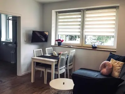 a living room with a table and a couch at DOMEK U MARKA Zator in Przeciszów