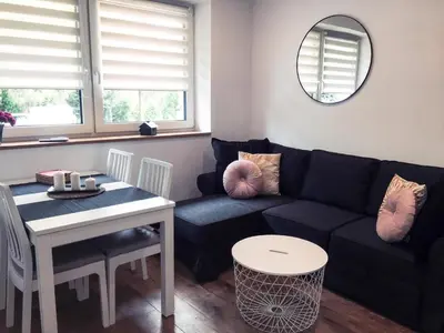 a living room with a couch and a table at DOMEK U MARKA Zator in Przeciszów