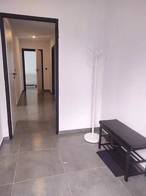 a hallway with a bench and a vase at Sarnie wzgórze Sucha Beskidzka sauna jacuzzi in Kuków