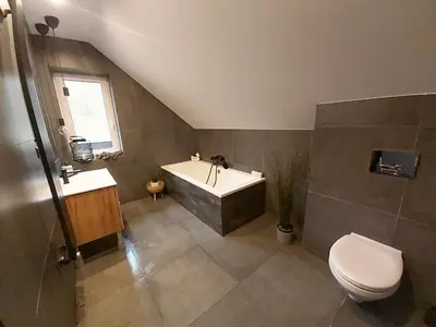 a bathroom with a tub and a toilet and a sink at Sarnie wzgórze Sucha Beskidzka sauna jacuzzi in Kuków